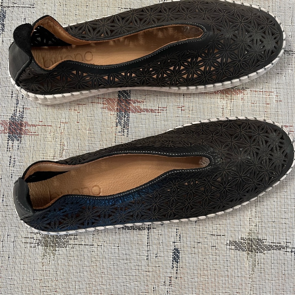Women's Black Slip-On leather Shoes with cut outs and never worn.
